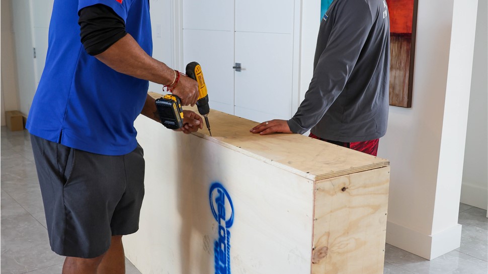 Solomon & Sons movers fastening down a custom crate.