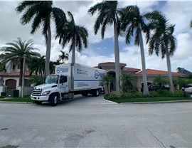 Solomon & Sons Miami moving truck parked in front of house.
