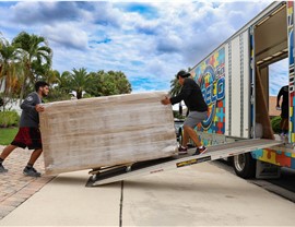 Loading furniture onto truck for interstate move.