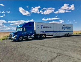 Solomon & Sons moving truck parked on side of cross-country highway.