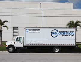 Miami moving truck parked in front of warehouse.