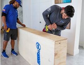 Solomon & Sons movers inspecting a custom crate before moving it.