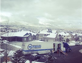 Solomon & Sons truck in snowy neighborhood after cross-country move.