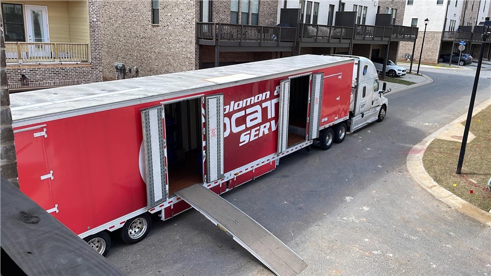 Solomon & Sons moving trailer with loading ramp during delivery in Silver Spring, Maryland.