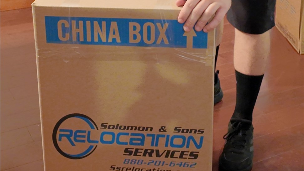 Solomon & Sons mover preparing a china box for fragile items