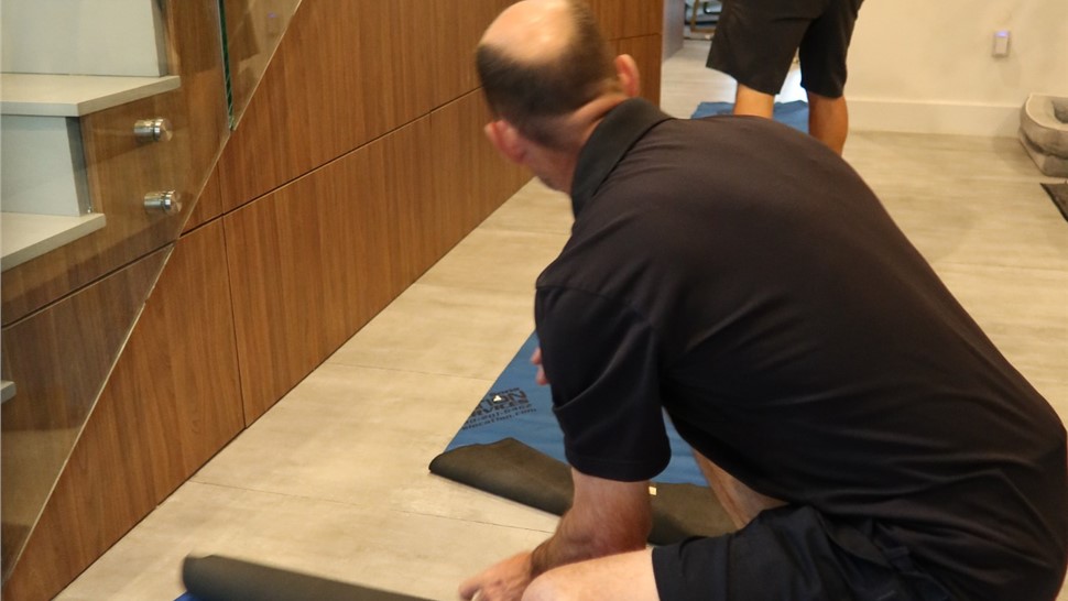Professional movers using floor protection inside a Miami home