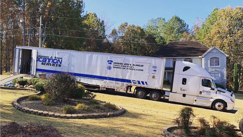 Long-distance moving truck parked outside residential home in South Carolina