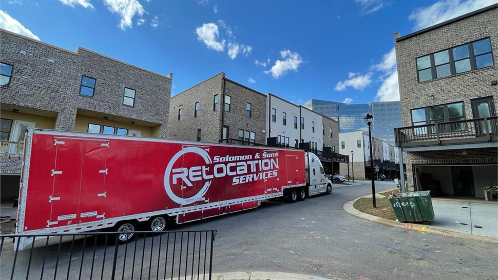 Solomon & Sons Relocation Services truck parked in a residential neighborhood during a move.