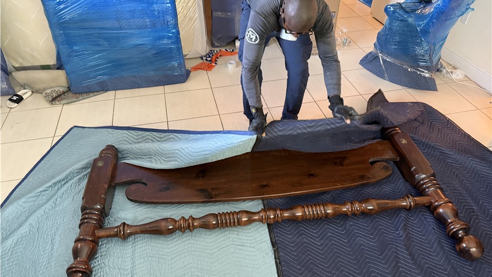 Miami movers disassembling and protecting wood furniture before long-distance move