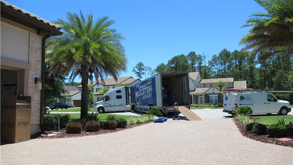 Solomon & Sons Relocation Services moving truck with ramp unloading furniture during a residential relocation