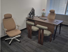 Private executive office with desk, chairs, and workstation relocated by Solomon & Sons during a Denver office move.