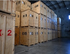 Rows of numbered wooden storage vaults stacked inside a warehouse
