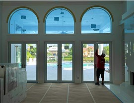 Professional installer working on impact replacement windows in a residential home