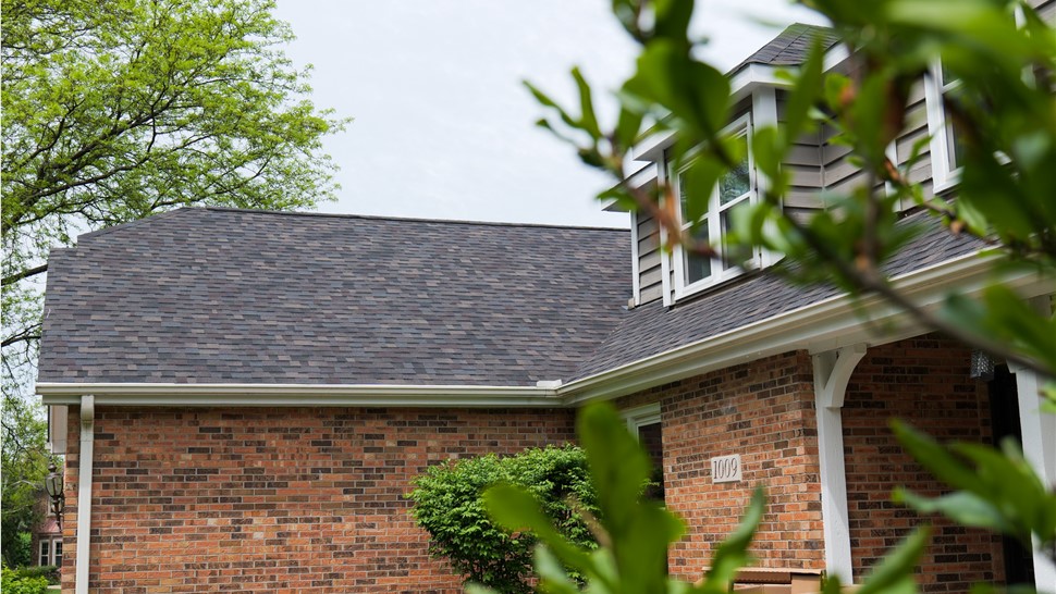 "Close-up view of a roof adorned with Owens Corner Black Sable Shingles, showcasing their striking dark color and enduring quality."