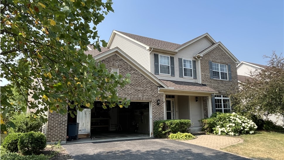 Unparalleled Roofing Craftsmanship: TTLC, Inc. Brings Oswego, IL to Life with Owens Corning Teak Shingle Roof - Impeccable Alignment, Straight Edges, and Artistic Precision.