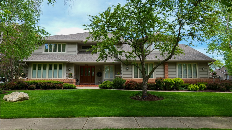 "A close-up of a roof featuring Owens Corner Driftwood Shingles, known for their durability and captivating natural appearance."