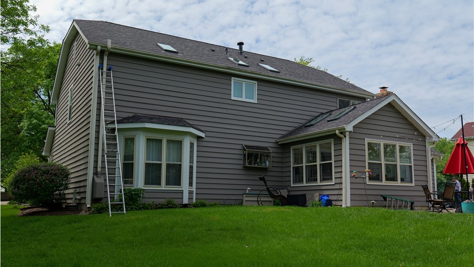 "The image depicts a roof embellished with Owens Corner Black Sable Shingles, exuding a classic and resilient charm with their deep, dark hue and superior craftsmanship."