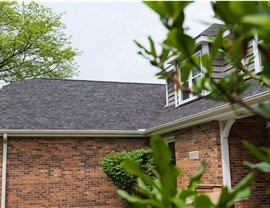 "Close-up view of a roof adorned with Owens Corner Black Sable Shingles, showcasing their striking dark color and enduring quality."