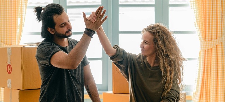 Couple celebrating because they know how to pack and prepare for your Bay Area move