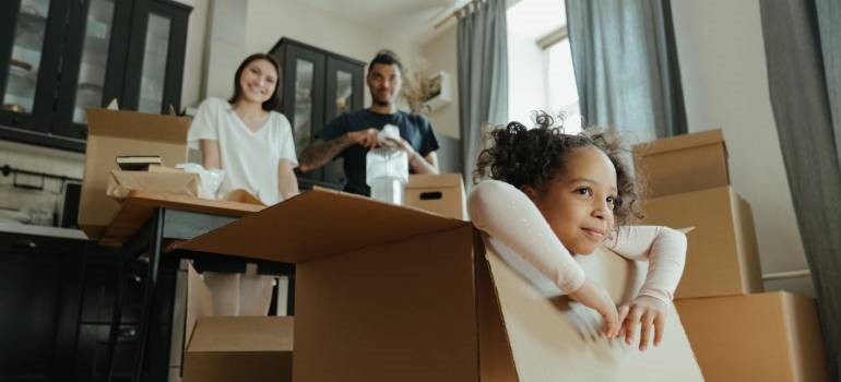 Family preparing boxes for relocation at home