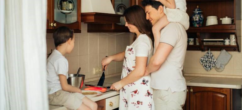 Family cooking breakfast together at home after facing challenges of moving to East Bay