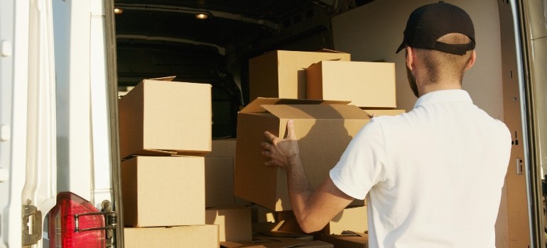 Man stacking boxes in a van