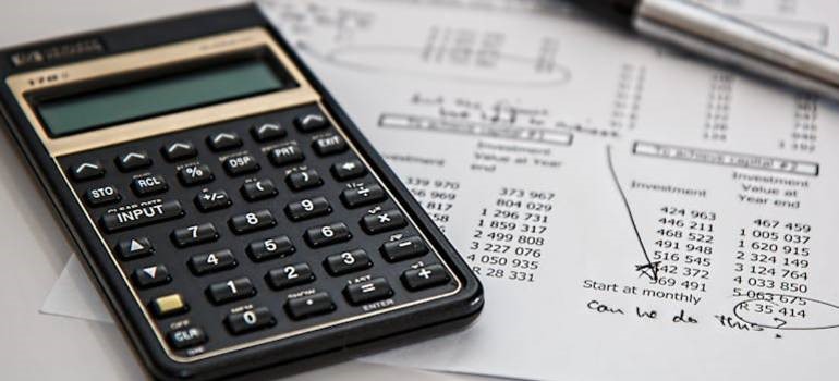 Close-up of calculator and financial documents on desk