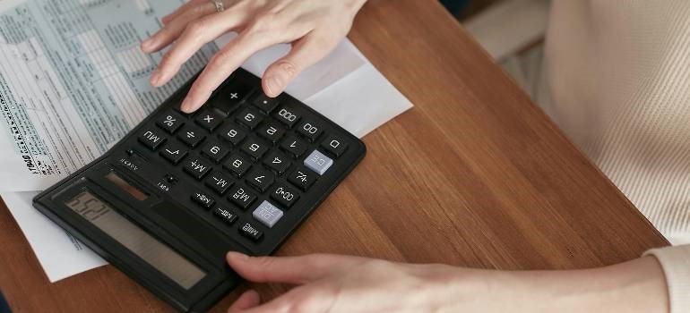 a person calculating long-term storage costs for furniture.