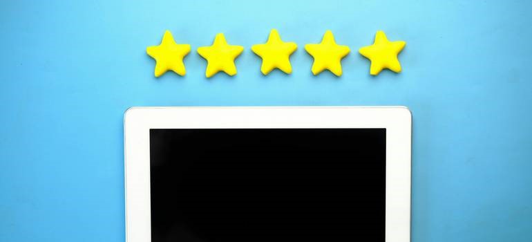 Tablet with five stars showing rating after checking fake reviews on social media