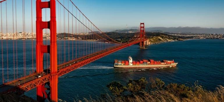 Cargo ship passing under the Golden Gate Bridge