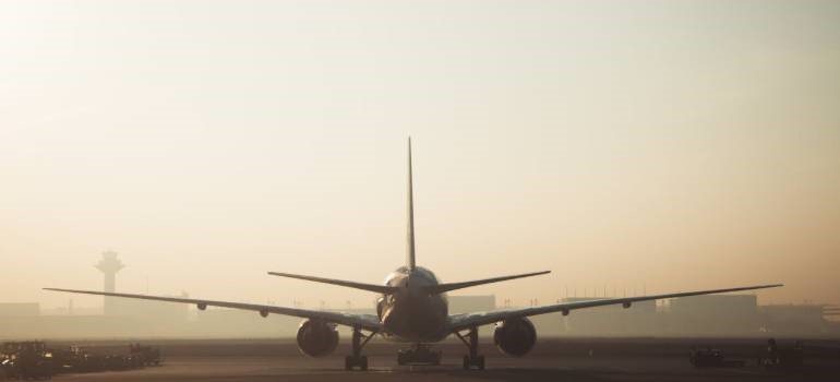 Airplane on runway during foggy morning