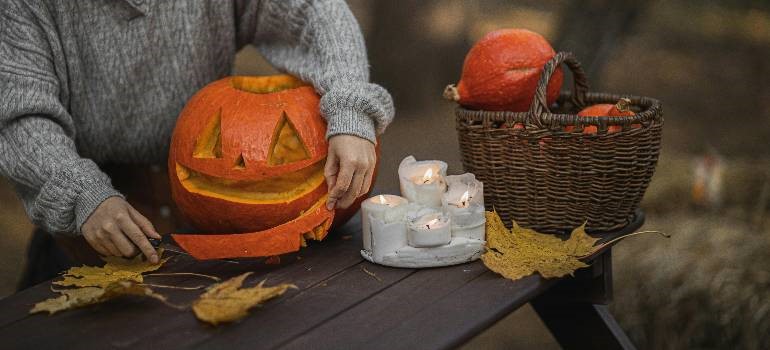 a person carving pumkins