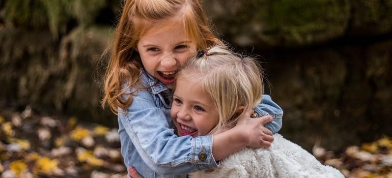 wo young girls hugging outdoors happily in one of the top places in the Bay Area to raise a family