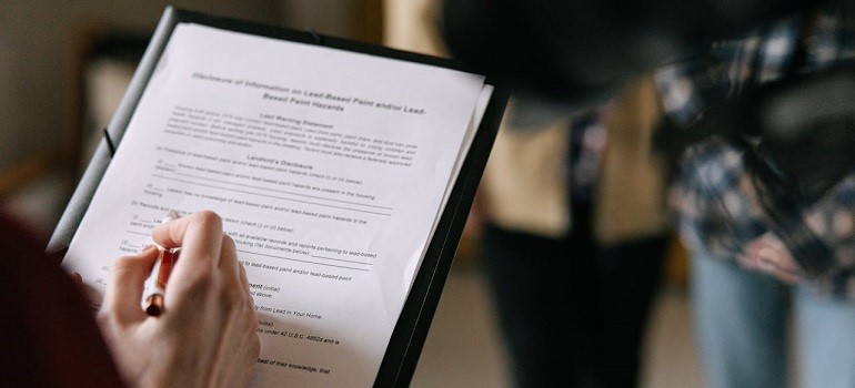A close-up of a person filling out a from