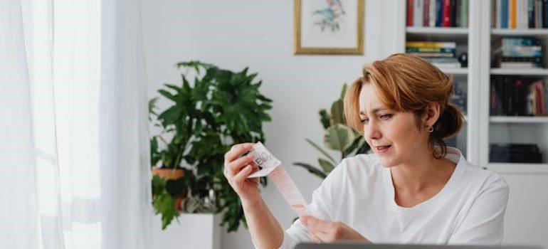 Worried woman checking bills after San Jose relocation