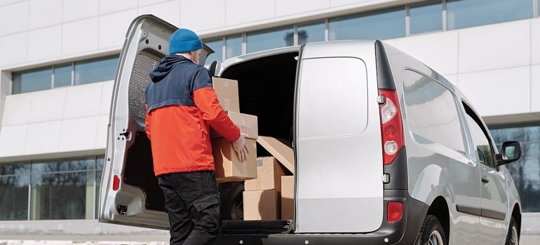 A person loading boxes into a moving van
