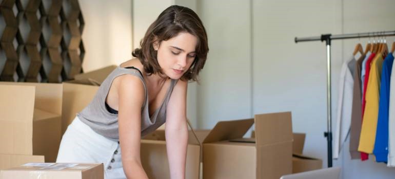 Woman organizing boxes to be ready for natural disasters in California