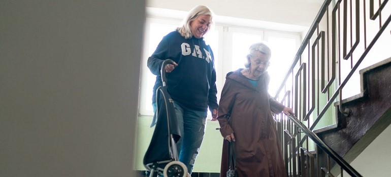 Senior walking downstairs in a home of a someone who knows how you prepare your home for an elderly parent