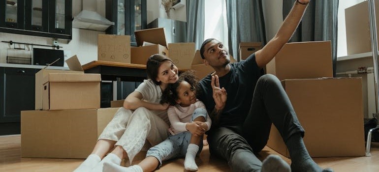 a family who hired movers in Redwood City CA to help them move, now relaxing in their new home