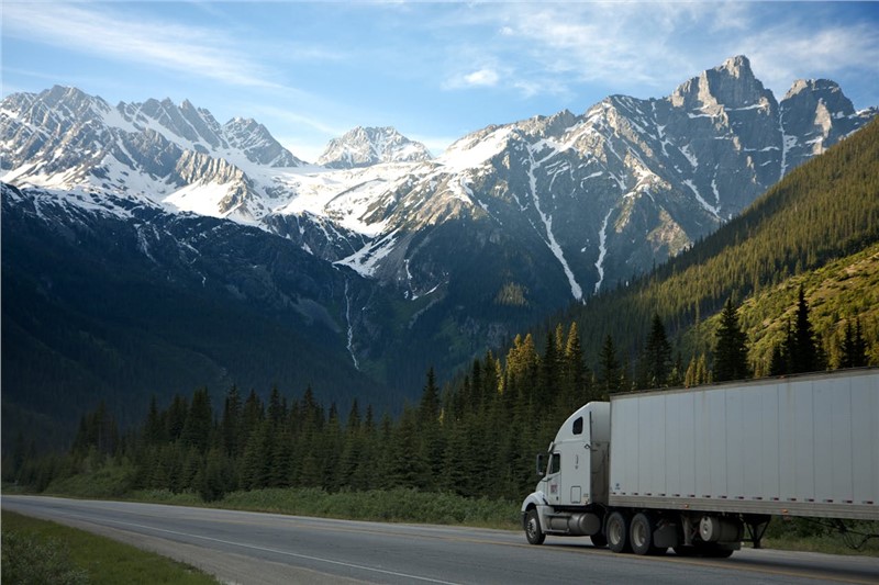 a truck on the road in the mountains 