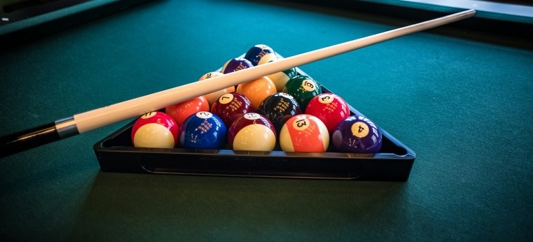 A  new pool table and sorted balls are ready for the next player.