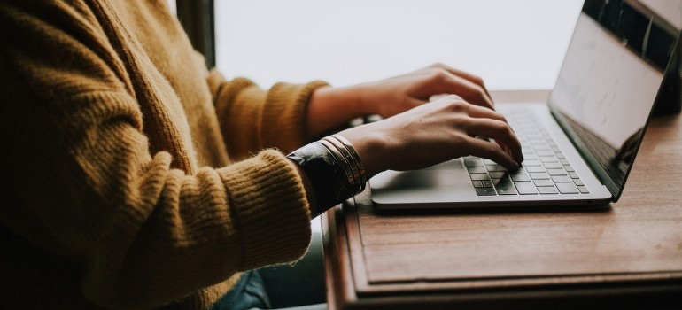 A person is sitting in front of a laptop. 