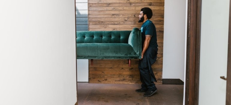 a man carrying a sofa 