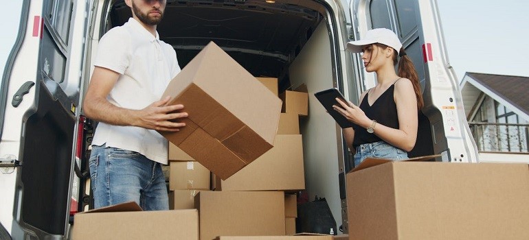 a couple surronded by moving boxes