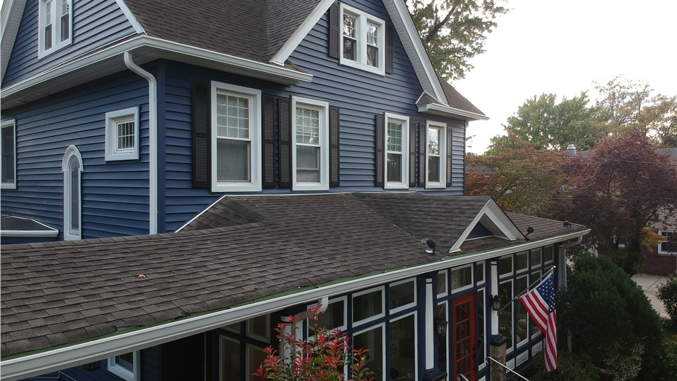 Blue vinyl siding installed on Victorian-style New Jersey home with white trim by Warner Exteriors