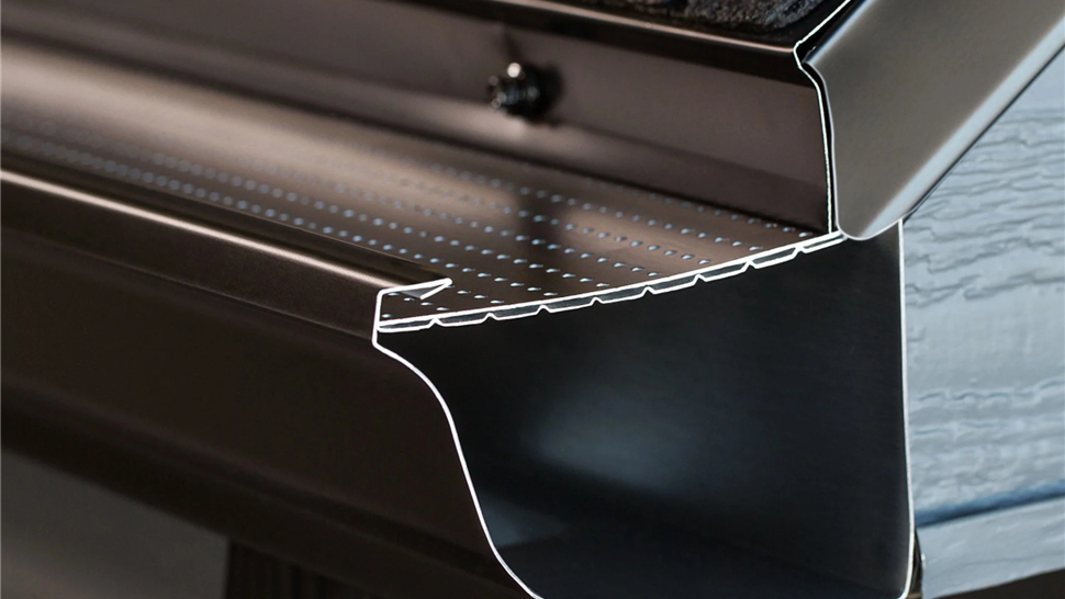 Close-up of premium gutter guard system showing perforated leaf protection installed on New Jersey home