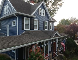 Blue vinyl siding installed on Victorian-style New Jersey home with white trim by Warner Exteriors