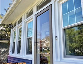 Front view of new ProVia vinyl windows installed on blue and white home in New Jersey