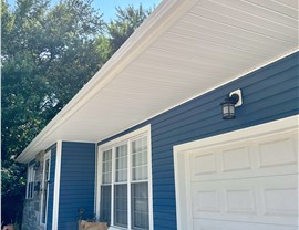 Blue vinyl siding with white trim installed on New Jersey ranch-style home by Warner Exteriors
