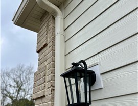 Light James Hardie fiber cement siding and trim installed on home with brick accents in New Jersey